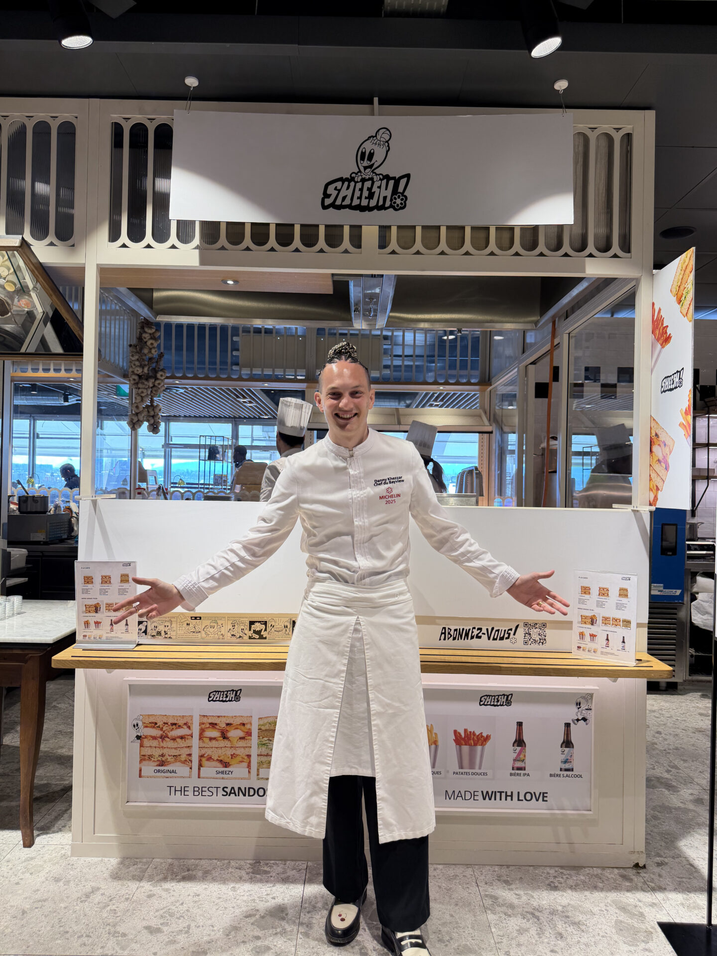 Chef souriant devant stand de sandwichs Sheesh