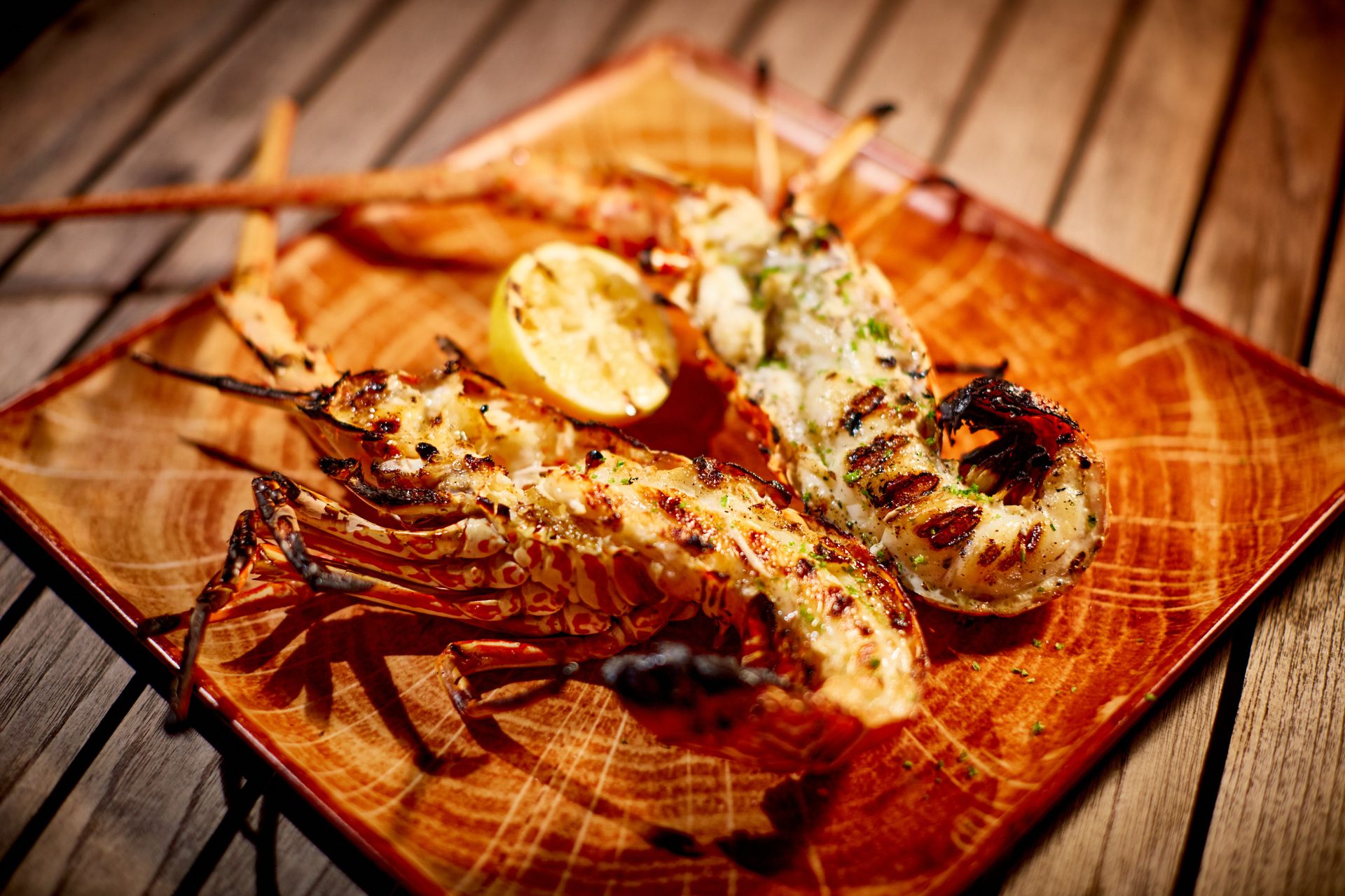 Langouste grillée servie avec citron et herbes